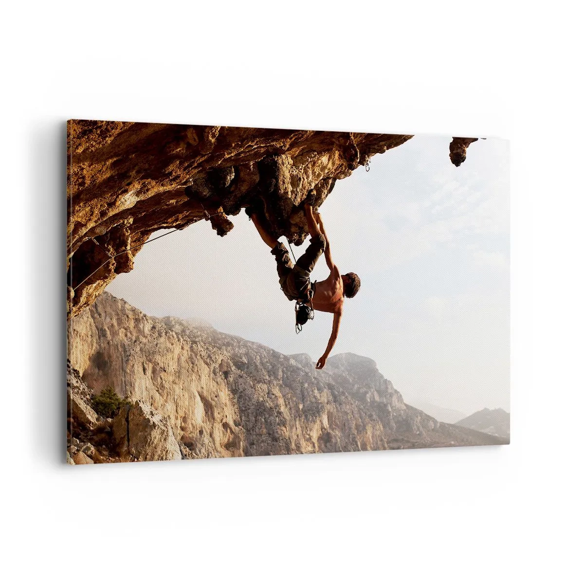 Bild auf Leinwand - Leinwandbild - Ein Kletterer auf einer steilen Klippe in den Bergen im Sonnenschein - 120x80cm - Die Welt ist in einer Hand auf einem Felsblock geschrumpft - Moderne Wanddekoration für Wohnzimmer und Schlafzimmer ARTTOR