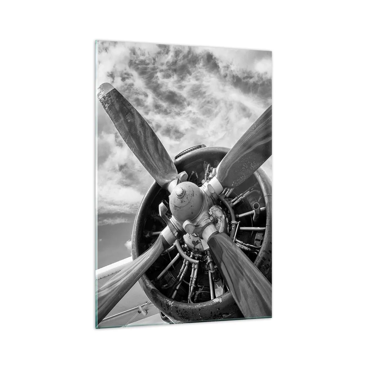 Glasbild - Bild auf glas - Ein Schwarzweißfoto eines Flugzeugpropellers vor einem dynamischen Himmel. - 70x100cm - Eroberer der Lüfte - Moderne Wanddekoration für Wohnzimmer und Schlafzimmer ARTTOR