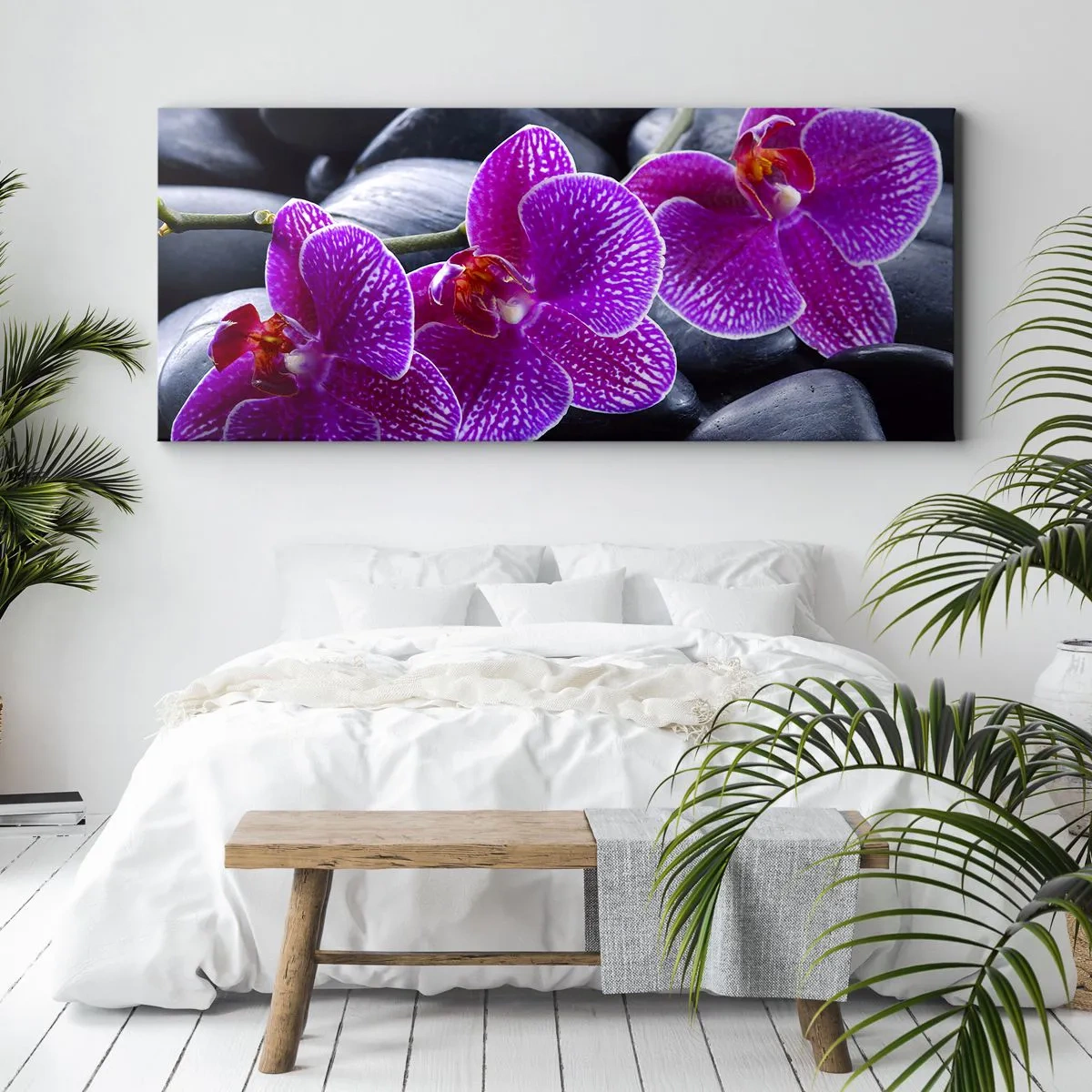 Bild auf Leinwand - Leinwandbild - Lila Orchideen vor einem Hintergrund aus schwarzen Steinen - 160x50cm - Die Steine
