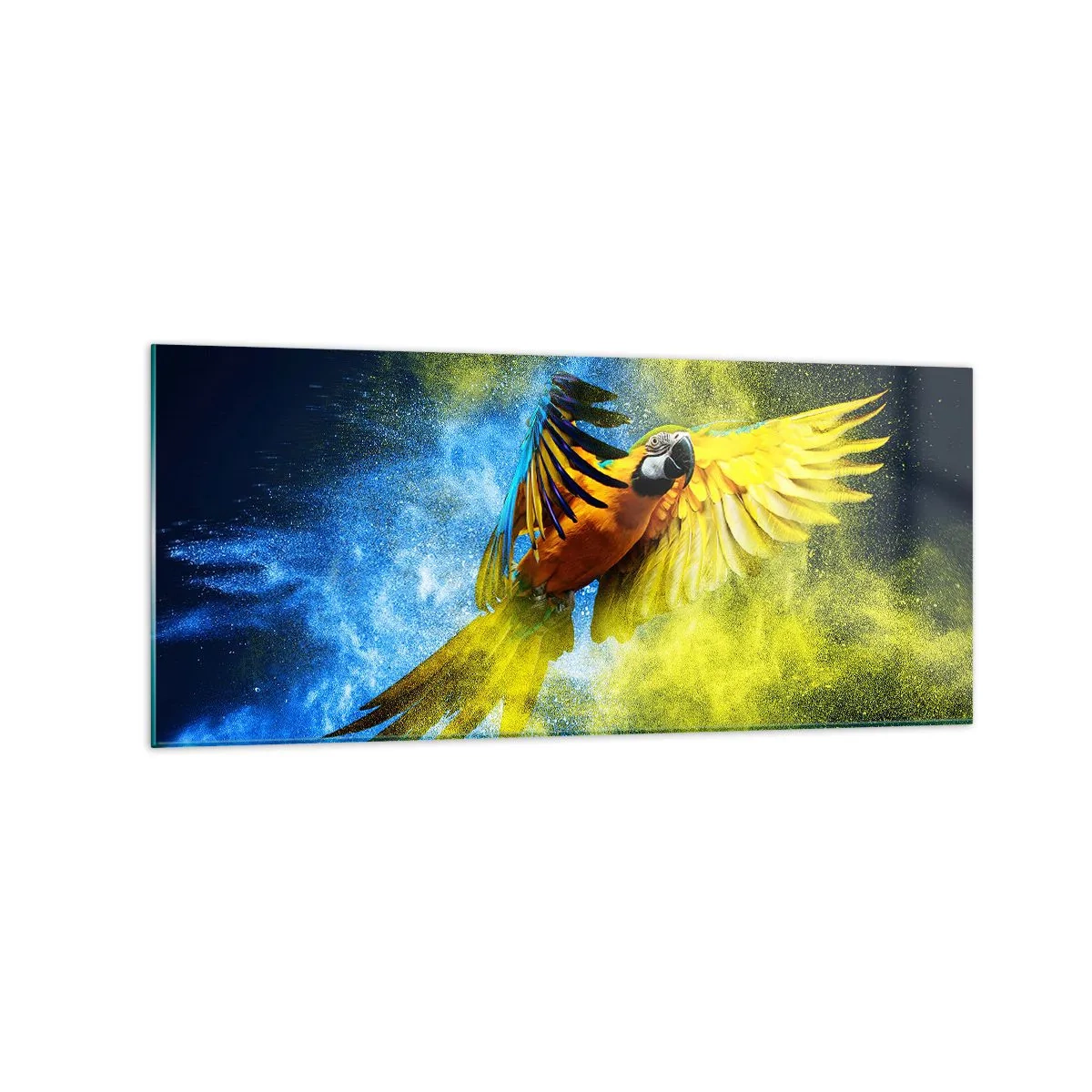 Glasbild - Bild auf glas - Ein Papagei im Flug vor einem Hintergrund aus farbenfrohen Explosionen in Gelb und Blau. - 120x50cm - Im blauen und goldenen Staub - Moderne Wanddekoration für Wohnzimmer und Schlafzimmer ARTTOR