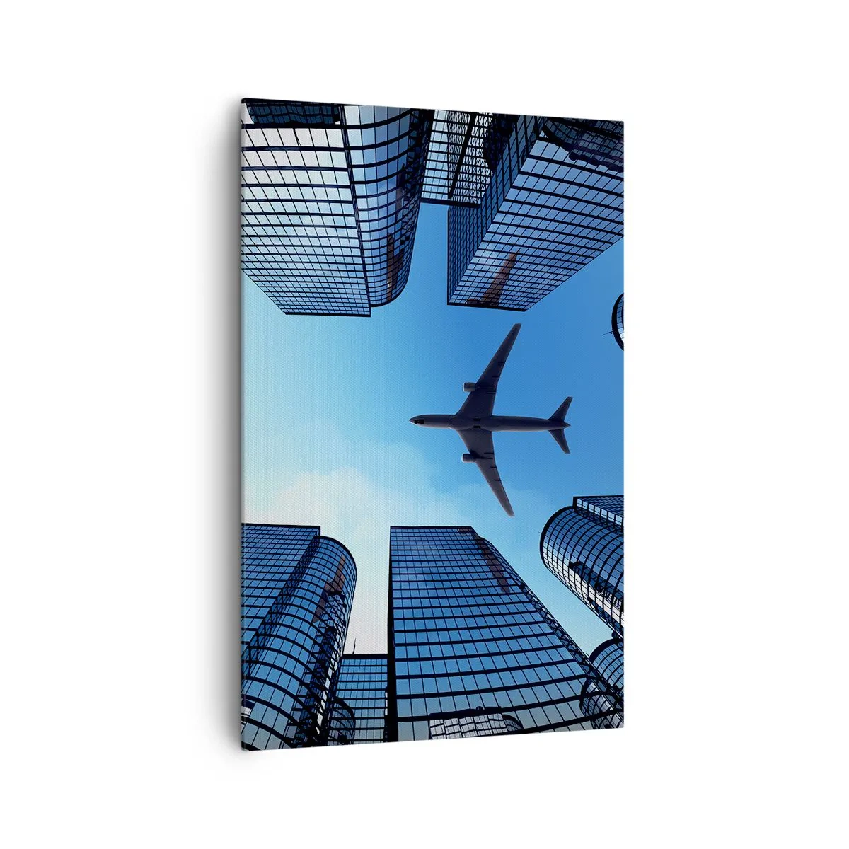 Bild auf Leinwand - Leinwandbild - Ein Flugzeug fliegt über moderne Wolkenkratzer im Stadtzentrum. - 80x120cm - Der Blick aus der Glasschlucht - Moderne Wanddekoration für Wohnzimmer und Schlafzimmer ARTTOR