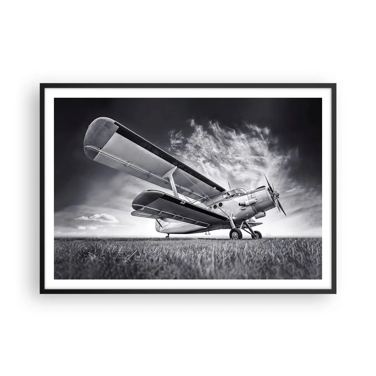 Poster in einem schwarzem Rahmen - Ein Flugzeug vor einem dramatischen Himmel in Schwarzweiß - 100x70cm - Der geflügelte Wanderer - Moderne Wanddekoration für Wohnzimmer und Schlafzimmer ARTTOR