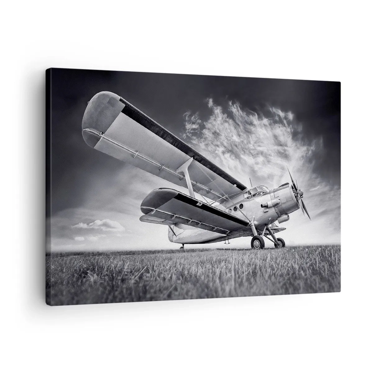 Bild auf Leinwand - Leinwandbild - Ein Flugzeug vor einem dramatischen Himmel in Schwarzweiß - 70x50cm - Der geflügelte Wanderer - Moderne Wanddekoration für Wohnzimmer und Schlafzimmer ARTTOR