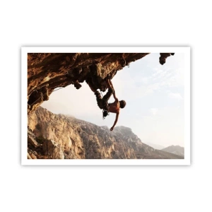 Poster - Ein Kletterer auf einer steilen Klippe in den Bergen im Sonnenschein - 100x70cm - Die Welt ist in einer Hand auf einem Felsblock geschrumpft - Moderne Wanddekoration für Wohnzimmer und Schlafzimmer ARTTOR