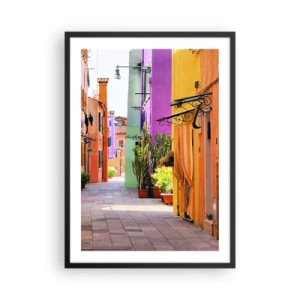 Poster in einem schwarzem Rahmen - Eine farbenfrohe Straße mit Pflanzen und lebendigen Gebäudefassaden - 50x70cm - Regenbogengasse - Moderne Wanddekoration für Wohnzimmer und Schlafzimmer ARTTOR