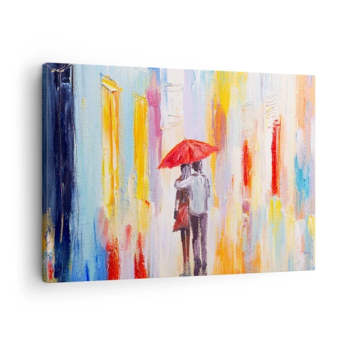 Bild auf Leinwand - Leinwandbild - Ein Paar unter einem roten Regenschirm mit bunten Gebäuden im Hintergrund. - 70x50cm - Lass es weiter regnen - Moderne Wanddekoration für Wohnzimmer und Schlafzimmer ARTTOR
