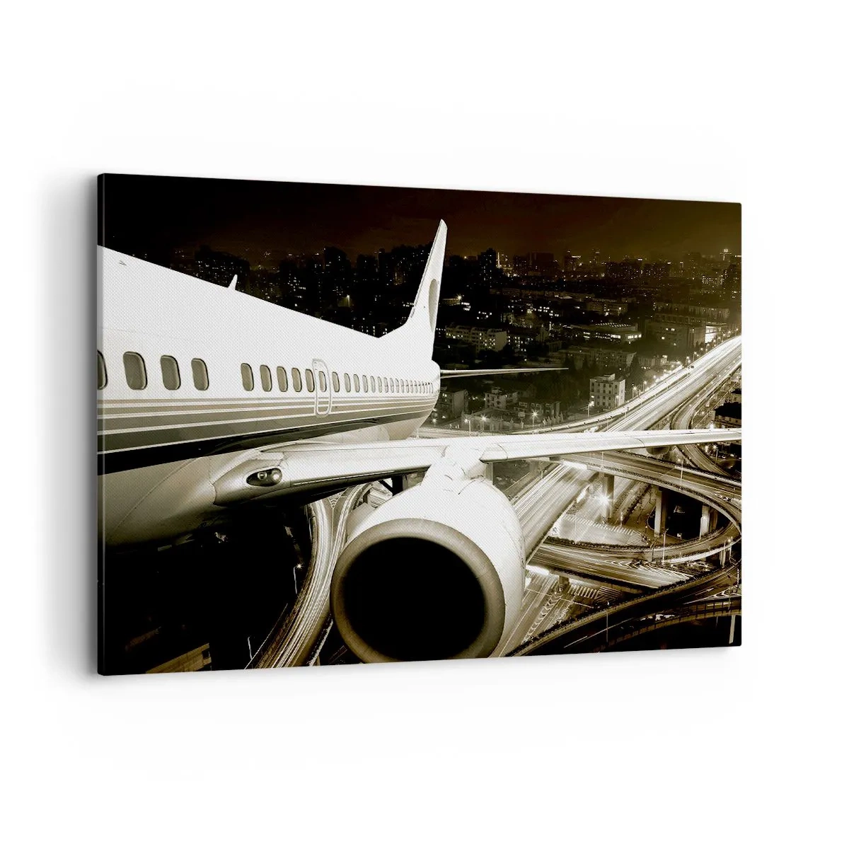 Bild auf Leinwand - Leinwandbild - Ein Flugzeug über einer nächtlichen Stadt mit beleuchteten Autobahnen - 100x70cm - In die Nacht fliegen - Moderne Wanddekoration für Wohnzimmer und Schlafzimmer ARTTOR