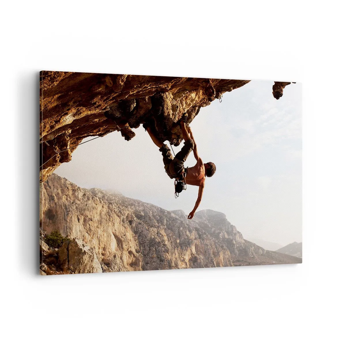 Bild auf Leinwand - Leinwandbild - Ein Kletterer auf einer steilen Klippe in den Bergen im Sonnenschein - 100x70cm - Die Welt ist in einer Hand auf einem Felsblock geschrumpft - Moderne Wanddekoration für Wohnzimmer und Schlafzimmer ARTTOR