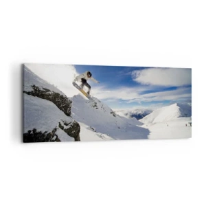 Bild auf Leinwand - Leinwandbild - Ein Snowboarder springt von einer Klippe mit schneebedeckten Bergen im Hintergrund. - 120x50cm - Freiheit ohne Grenzen - Moderne Wanddekoration für Wohnzimmer und Schlafzimmer ARTTOR