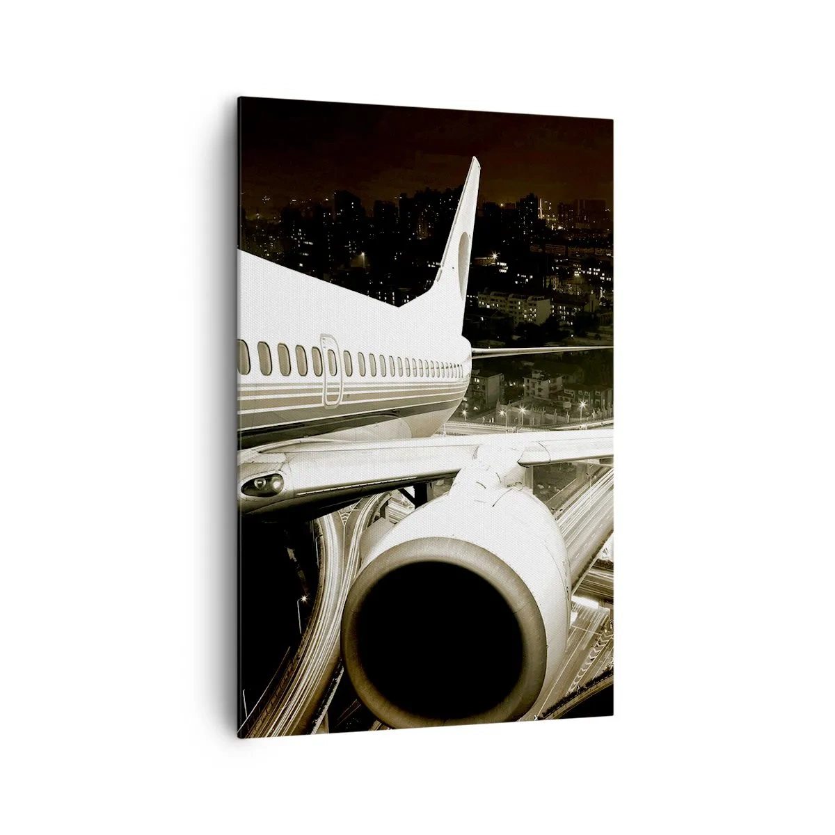Bild auf Leinwand - Leinwandbild - Ein Flugzeug über einer nächtlichen Stadt mit beleuchteten Autobahnen - 80x120cm - In die Nacht fliegen - Moderne Wanddekoration für Wohnzimmer und Schlafzimmer ARTTOR