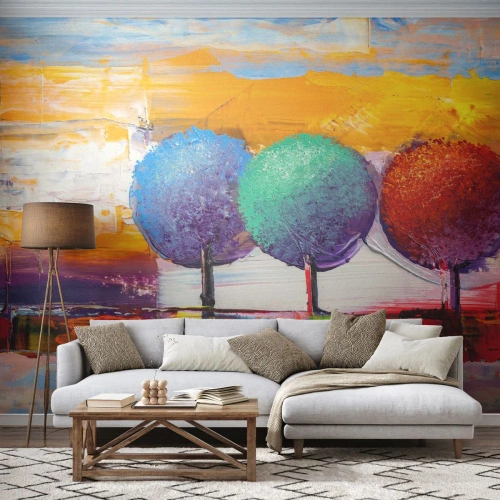 Fototapete Premium Sand - Ein abstraktes Gemälde von drei bunten Bäumen vor einem Landschaftshintergrund. - 100x70cm - Aller guten Dinge sind drei - Moderne Wanddekoration für Wohnzimmer und Schlafzimmer ARTTOR