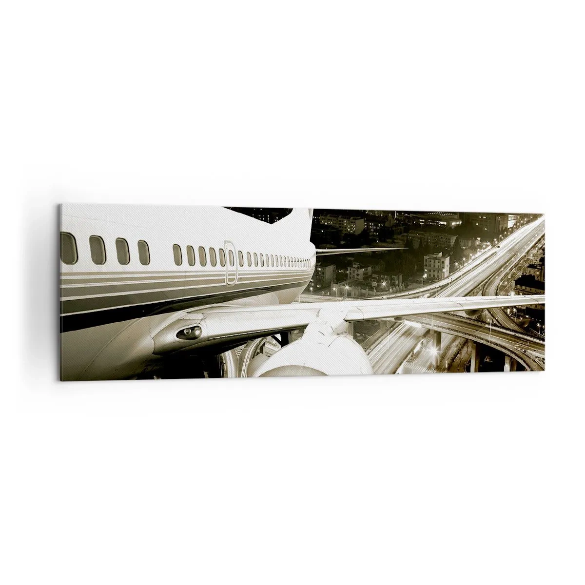Bild auf Leinwand - Leinwandbild - Ein Flugzeug über einer nächtlichen Stadt mit beleuchteten Autobahnen - 160x50cm - In die Nacht fliegen - Moderne Wanddekoration für Wohnzimmer und Schlafzimmer ARTTOR