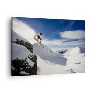Bild auf Leinwand - Leinwandbild - Ein Snowboarder springt von einer Klippe mit schneebedeckten Bergen im Hintergrund. - 70x50cm - Freiheit ohne Grenzen - Moderne Wanddekoration für Wohnzimmer und Schlafzimmer ARTTOR
