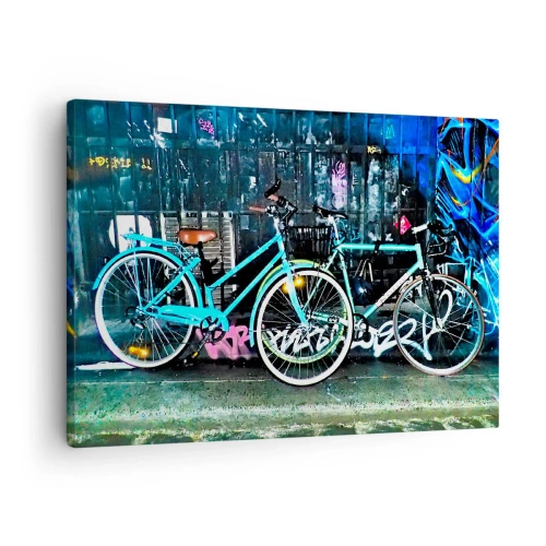 Bild auf Leinwand - Leinwandbild - Zwei türkisfarbene Fahrräder vor einer urbanen Graffiti-Kulisse. - 70x50cm - Die Stadt ruft - Moderne Wanddekoration für Wohnzimmer und Schlafzimmer ARTTOR